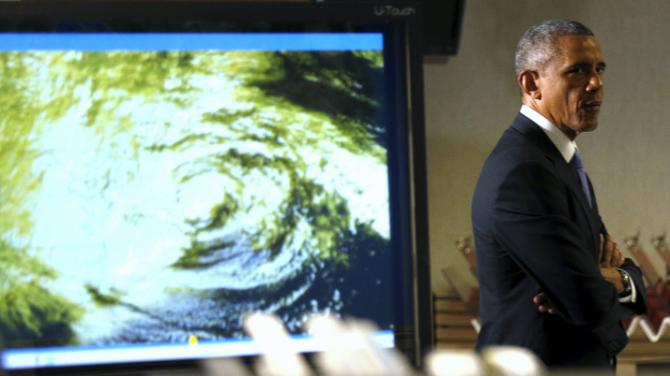U.S. President Barack Obama passes an image of a hurricane during a tour of the National Hurricane Center in Miami, Florida, May 28, 2015. REUTERS/Kevin Lamarque