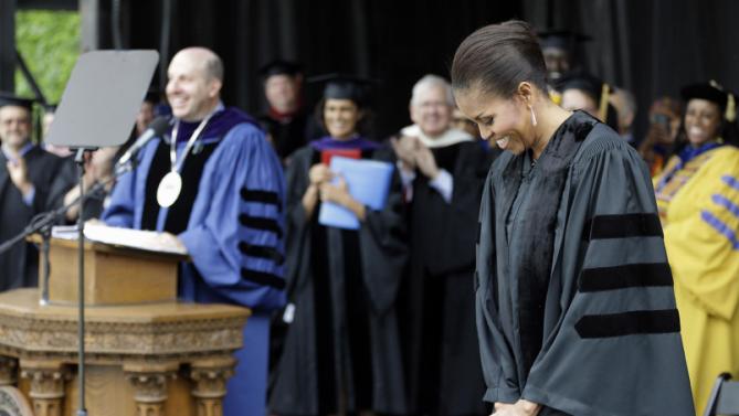 First lady Michelle Obama smiles as she is introduced by Oberlin College President Marvin Krislov before receiving an Honorary Degree of Doctor of Humanities from Oberlin College, Monday, May 25, 2015, in Oberlin, Ohio. (AP Photo/Tony Dejak)