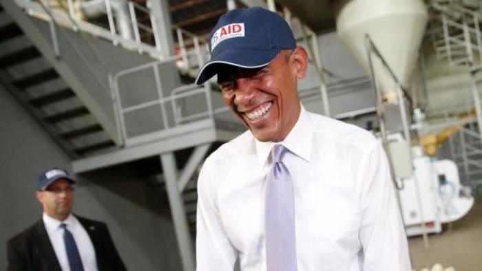 U.S. President Barack Obama laughs after commenting on his press corps, who were wearing hair nets on a tour of the Faffa Food factory in Addis Ababa, Ethiopia July 28, 2015. Obama told Ethiopia's leaders on Monday that allowing more political freedoms would strengthen the African nation, which had already lifted millions out of a poverty once rooted in recurring famine. REUTERS/Jonathan Ernst