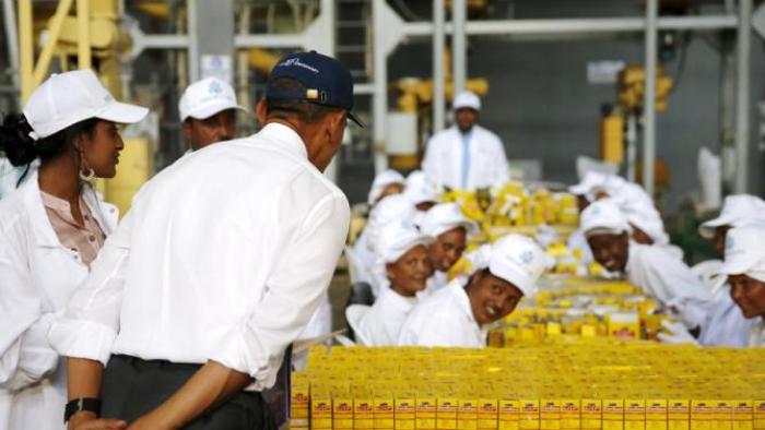 U.S. President Barack Obama (2nd L) bows as he greets workers during a tour of the Faffa Food factory in Addis Ababa, Ethiopia July 28, 2015. Obama told Ethiopia's leaders on Monday that allowing more political freedoms would strengthen the African nation, which had already lifted millions out of a poverty once rooted in recurring famine. REUTERS/Jonathan Ernst