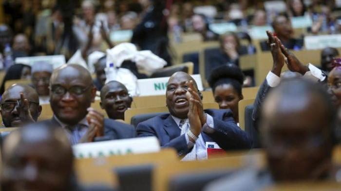 Delegates react to remarks by U.S. President Barack Obama at the African Union in Addis Ababa, Ethiopia July 28, 2015. Obama toured a U.S.-supported food factory in Ethiopia on Tuesday on the last leg of an Africa trip, before winding up his visit at the African Union where he will become the first U.S. president to address the 54-nation body. REUTERS/Jonathan Ernst