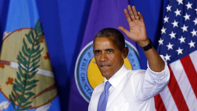 President Barack Obama waves as he arrives to speak at Durant High School in Durant, Okla., Wednesday, July 15, 2015. (AP Photo/Sue Ogrocki)