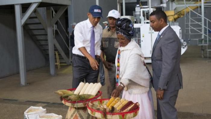U.S. President Barack Obama, left, talks with farmer Gifty Jemal Hussein, second from right, about her corn during a tour of Faffa Food, on Tuesday, July 28, 2015, in Addis Ababa, Ethiopia. On the final day of his African trip, Obama is focusing on economic opportunities and African security. (AP Photo/Evan Vucci)