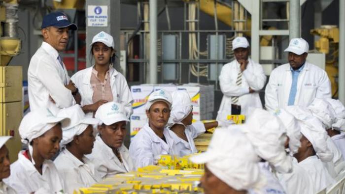 U.S. President Barack Obama watches workers package food during a tour of Faffa Food, Tuesday, July 28, 2015, in Addis Ababa, Ethiopia. On the final day of his African trip, Obama is focusing on economic opportunities and African security. (AP Photo/Evan Vucci)