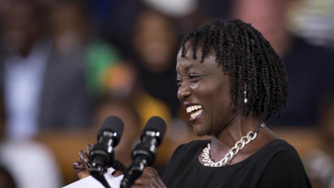 Auma Obama, half-sister of President Barack Obama, introduces him prior to giving a speech at the Safaricom Indoor Arena in the Kasarani area of Nairobi, Kenya Sunday, July 26, 2015. Obama is traveling on a two-nation African tour where he will become the first sitting U.S. president to visit Kenya and Ethiopia. (AP Photo/Ben Curtis)