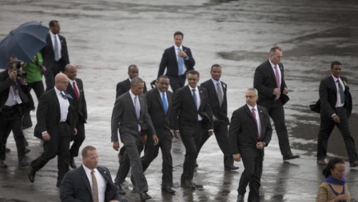 Surrounded by Secret Servicemen, US President Barack Obama, centre left, walks to Airforce One, with Ethiopian Prime Minister Hailemariam Desalegn,  as he departs Bole International Airport, Tuesday, July 28, 2015, in Addis Ababa, on the final day of his visit in Ethiopia. Closing a historic visit to Africa, President Barack Obama on Tuesday urged the continent's leaders to prioritize creating jobs and opportunity for the next generation of young people or risk sacrificing future economic potential to further instability and disorder. (AP Photo/Sayyid Azim)