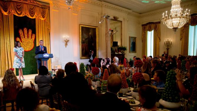President Barack Obama, accompanied by first lady Michelle Obama, delivers remarks as he makes an unannounced appearance at the Kids' State Dinner in the East Room at the White House, Friday, July 10, 2015, in Washington. The children present were part of the 2015 winners of the Healthy Lunchtime Challenge. (AP Photo/Andrew Harnik)