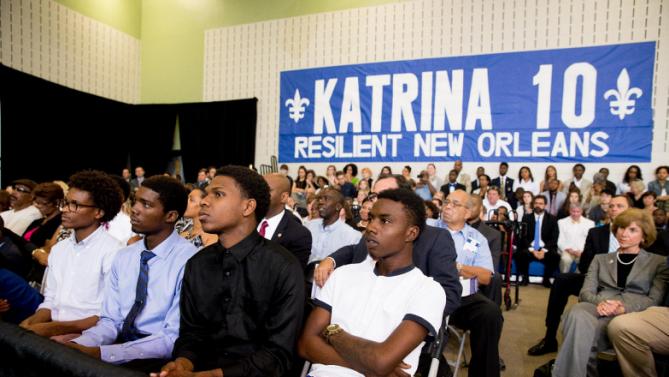 Four young men who's lives were affected by Hurricane Katrina listen as President Barack Obama delivers remarks at Andrew P. Sanchez Community Center in New Orleans, Thursday, Aug. 27, 2015, for the 10th anniversary since the devastation of Hurricane Katrina. The young men had lunch with the president and discussed resiliency in the face of adversity. (AP Photo/Andrew Harnik)