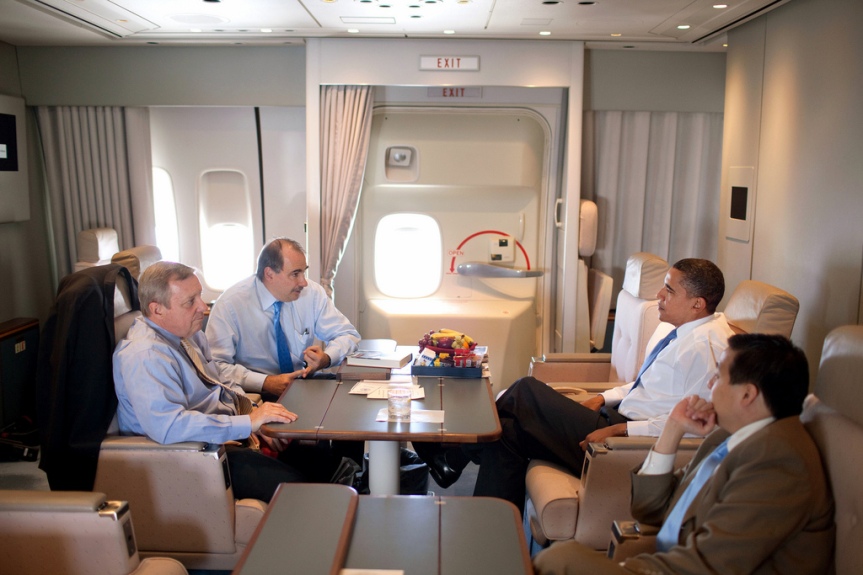 President Barack Obama talks with Senior Advisor David Alexrod and Se. Dick Durbin, (D-Ill.), on Air Force One en route to Portsmouth, N.H. for a town hall meeting about health care reform August 11, 2009.  (Official White House photo by Pete Souza) This official White House photograph is being made available only for publication by news organizations and/or for personal use printing by the subject(s) of the photograph. The photograph may not be manipulated in any way and may not be used in commercial or political materials, advertisements, emails, products, promotions that in any way suggests approval or endorsement of the President, the First Family, or the White House.