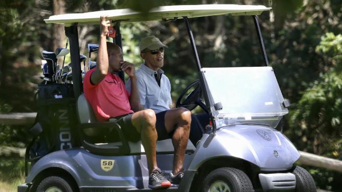 NBA Basketball player Ray Allen, left, sits in a golf cart with President Barack Obama while golfing Wednesday, Aug. 12, 2015, at Farm Neck Golf Club, in Oak Bluffs, Mass., on the island of Martha's Vineyard. The president, first lady Michelle Obama, and daughter Sasha are vacationing on the island. (AP Photo/Steven Senne)
