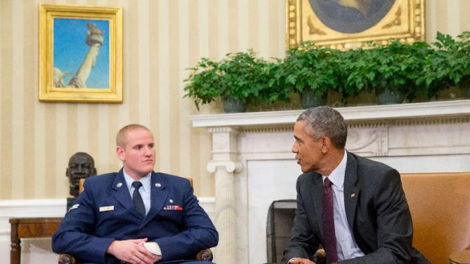 CORRECTS TO PARIS-BOUND TRAIN - President Barack Obama speaks to Air Force Airman 1st Class Spencer Stone, left, as he meets with Stone, Oregon National Guardsman Alek Skarlatos, and Anthony Sadler in the Oval Office of the White House in Washington, Thursday, Sept. 17, 2015, to honor them for heroically subduing a gunman on a Paris-bound passenger train last month. (AP Photo/Andrew Harnik)