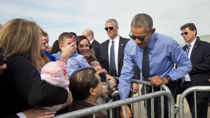 President Barack Obama greets guests on the tarmac by before boarding Air Force One at Moffett Federal Airfield in Mountain View, Calif., Thursday, Feb. 11, 2016. Obama is traveling Los Angeles to tape an appearance on the Ellen DeGeneres Show and attend a pair of private Democratice fundraisers later today. (AP Photo/Pablo Martinez Monsivais)