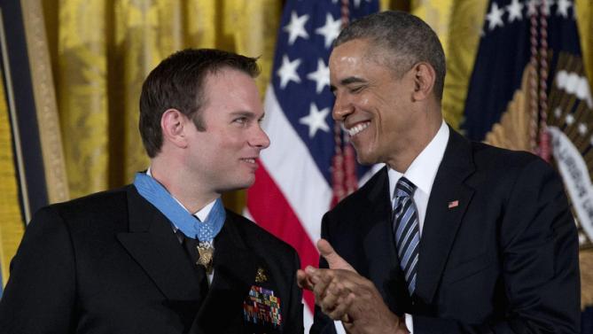 President Barack Obama applauds after presenting the Medal of Honor to Senior Chief Special Warfare Operator Edward Byers during a ceremony in the East Room of the White House in Washington, Monday, Feb. 29, 2016. U.S. Navy. Senior Chief Byers received the Medal of Honor for his courageous actions while serving as part of a team that rescued an American civilian being held hostage in Afghanistan on December 8-9, 2012. (AP Photo/Carolyn Kaster)