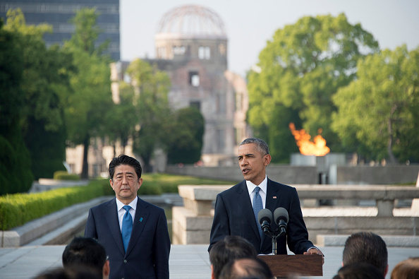 US President Barack Obama delivers remarks after laying a wreath at the Hiroshima Peace Memorial Park as Japan's Prime Minister Shinzo Abe (L) looks on, in Hiroshima on May 27, 2016. Obama on May 27 paid moving tribute to victims of the world's first nuclear attack. / AFP / JIM WATSON (Photo credit should read JIM WATSON/AFP/Getty Images)
