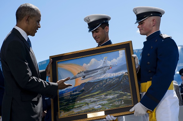 US President Barack Obama is presented a painting during a graduation ceremony at the US Air Force Academy's Falcon Stadium June 2, 2016 in Colorado Springs, Colorado. / AFP / Brendan Smialowski (Photo credit should read BRENDAN SMIALOWSKI/AFP/Getty Images)