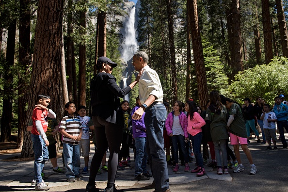 US First Lady Michelle Obama and US President Barack Obama talk after speaking to children about the "Every Kid in the Park" initiative in Yosemite National Park, California, while celebrating the 100th year of US National Parks June 18, 2016. / AFP / Brendan Smialowski (Photo credit should read BRENDAN SMIALOWSKI/AFP/Getty Images)