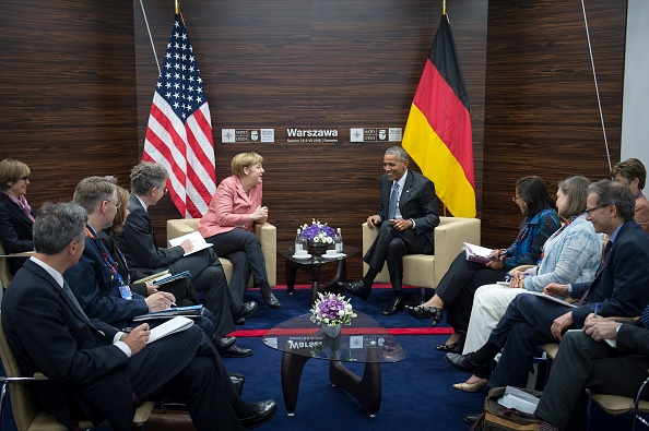 WARSAW, POLAND - JULY 09: In this handout photo provided by the German Government Press Office (BPA), German Chancellor Angela Merkel and President Barack Obama along with their interpreters and advisers meet for talks during the Warsaw NATO Summit on July 9, 2016 in Warsaw, Poland. NATO member heads of state, foreign ministers and defense ministers are gathering for a two-day summit that will end later today. (Photo by Guido Bergmann/Bundesregierung via Getty Images)