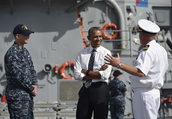 US President Barack Obama (C) listens to a commander as he tours the USS Ross Navy ship at the Naval Station Rota, in Rota, southwestern Spain on July 10, 2016. Obama said he will cut short a foreign trip and visit Dallas next week as the shooting rampage by the black army veteran, who said he wanted to kill white cops, triggered urgent calls to mend troubled race relations in the United States. / AFP / MANDEL NGAN (Photo credit should read MANDEL NGAN/AFP/Getty Images)